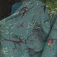 video showing tropical bird blanket with dark green front and light purple reverse