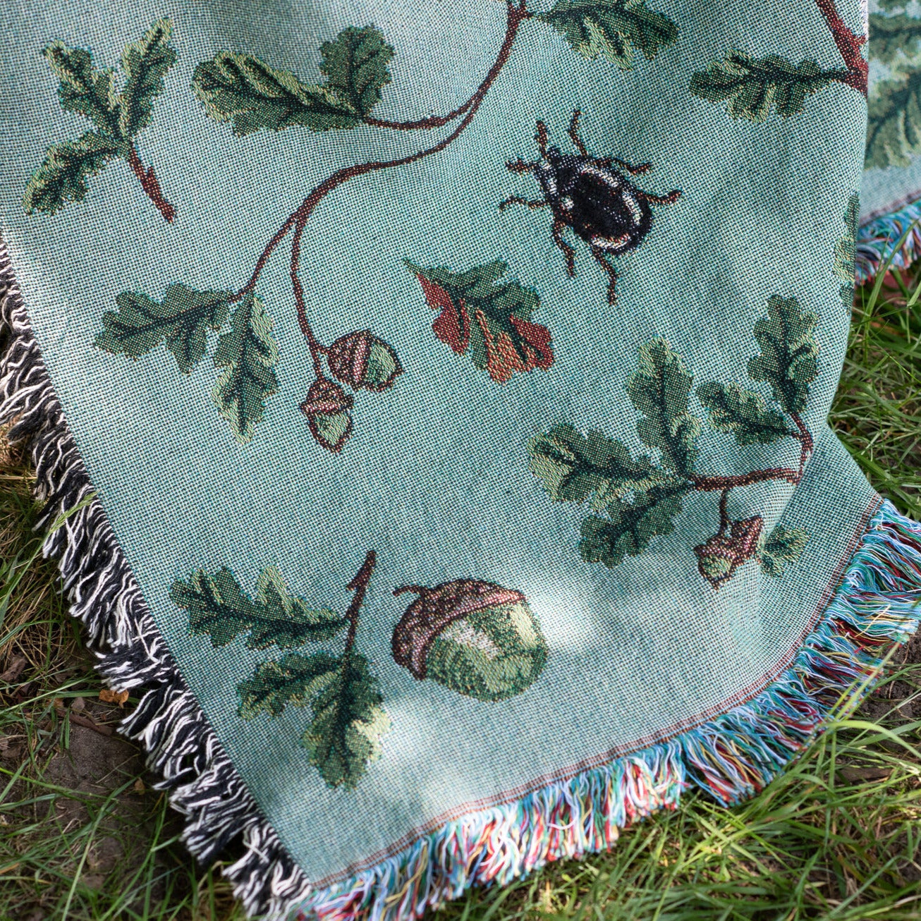 Jade woven blanket showing oak and beetle pattern