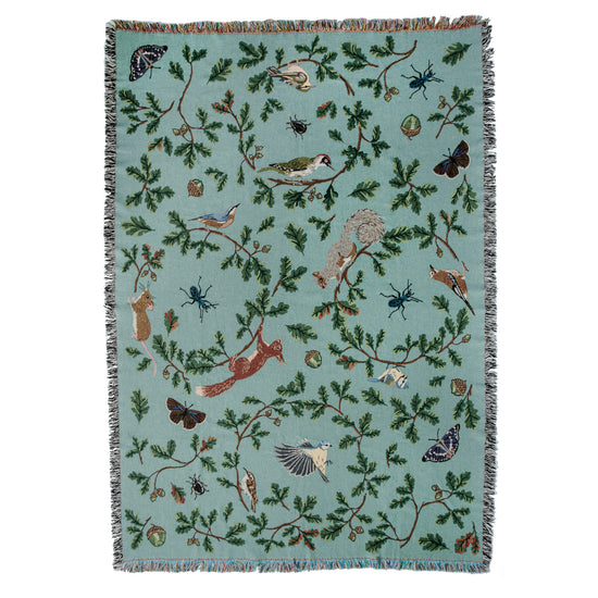Jade woven blanket with red squirrel, oak, butterflies and birds pattern