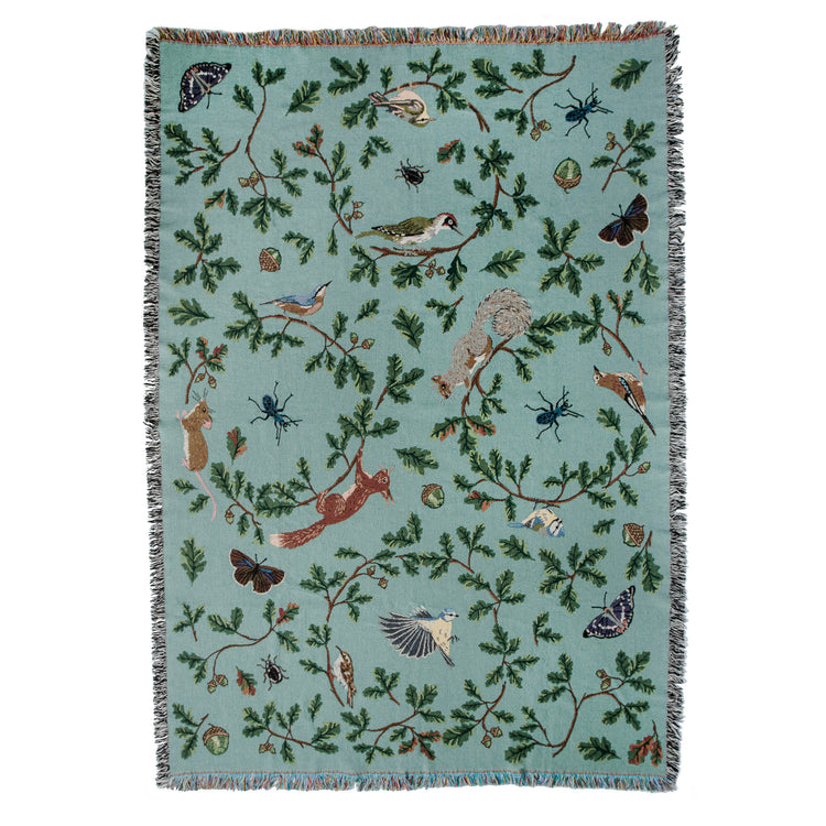 Jade woven blanket with red squirrel, oak, butterflies and birds pattern