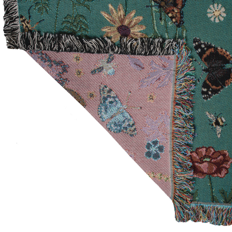 Detail of the purple reverse of woven blanket with butterflies and flowers