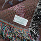 detail of woven blanket with arcana limited edition label sewn on