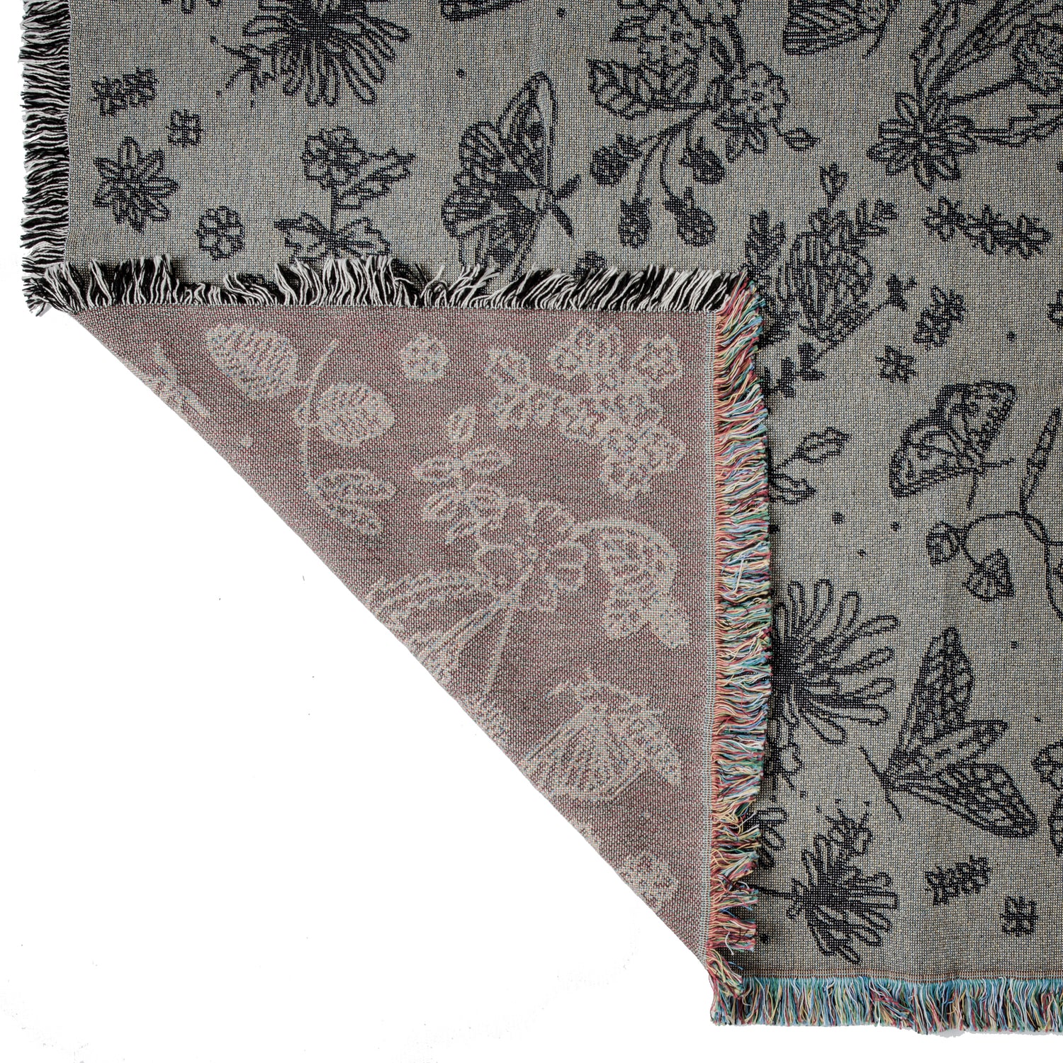 detail of Pretty grey blanket with black pattern of moths, berries, leaves and flowers