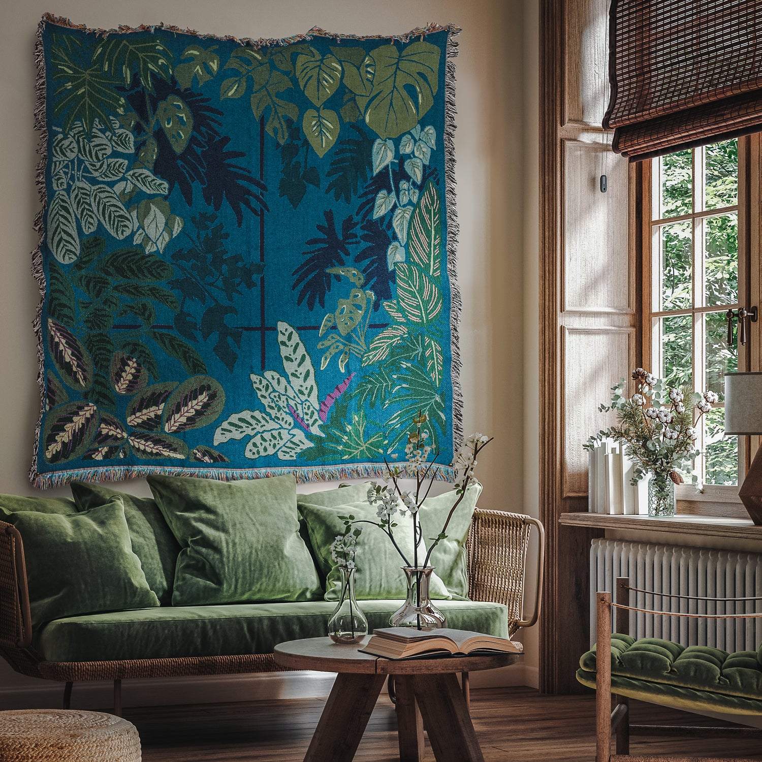 Teal and green woven blanket featuring houseplants hung as a tapestry on the wall  in a living room
