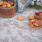 cream two tone woven picnic blanket featuring oak woodland butterfies and birds with french pastries and fruit