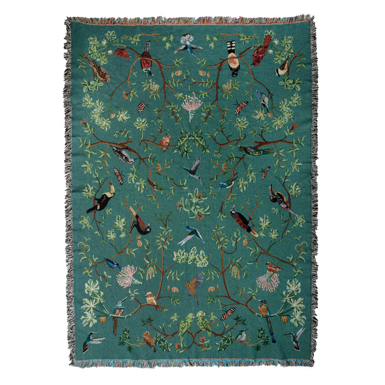 tropical bird woven blanket with fringe, showing hummingbirds and toucans